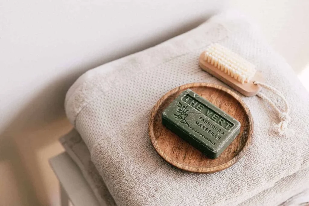 Bar of French soap next to a grooming brush