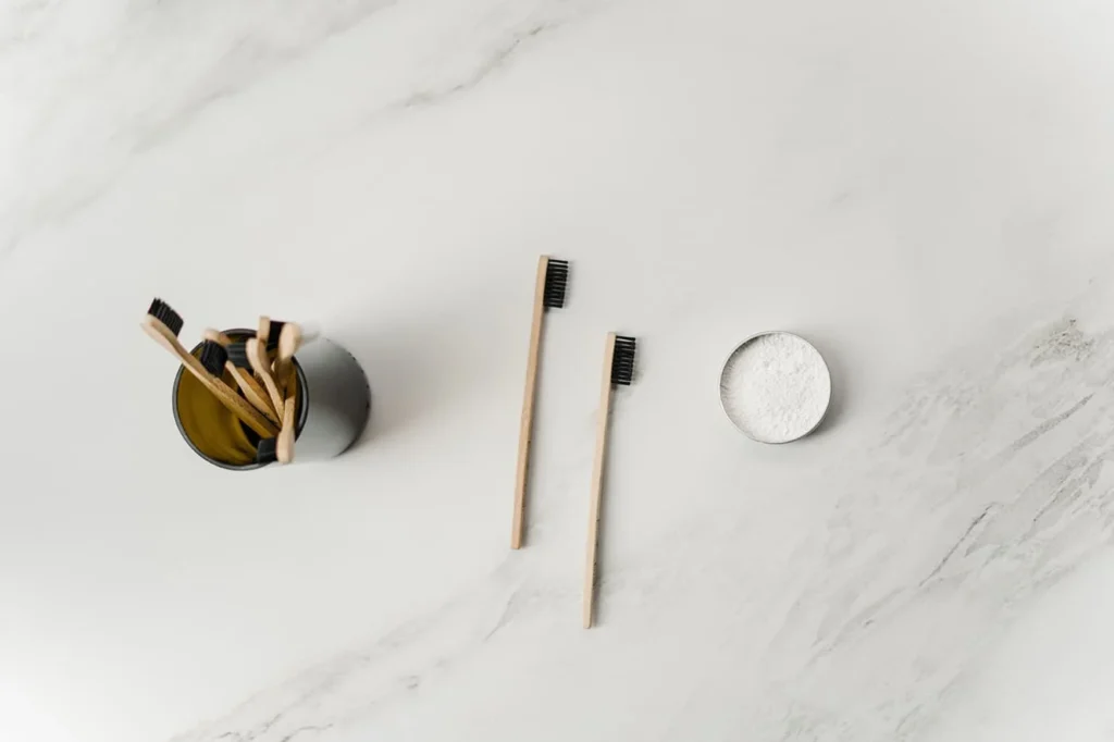 Makeup brushes beside loose setting powder